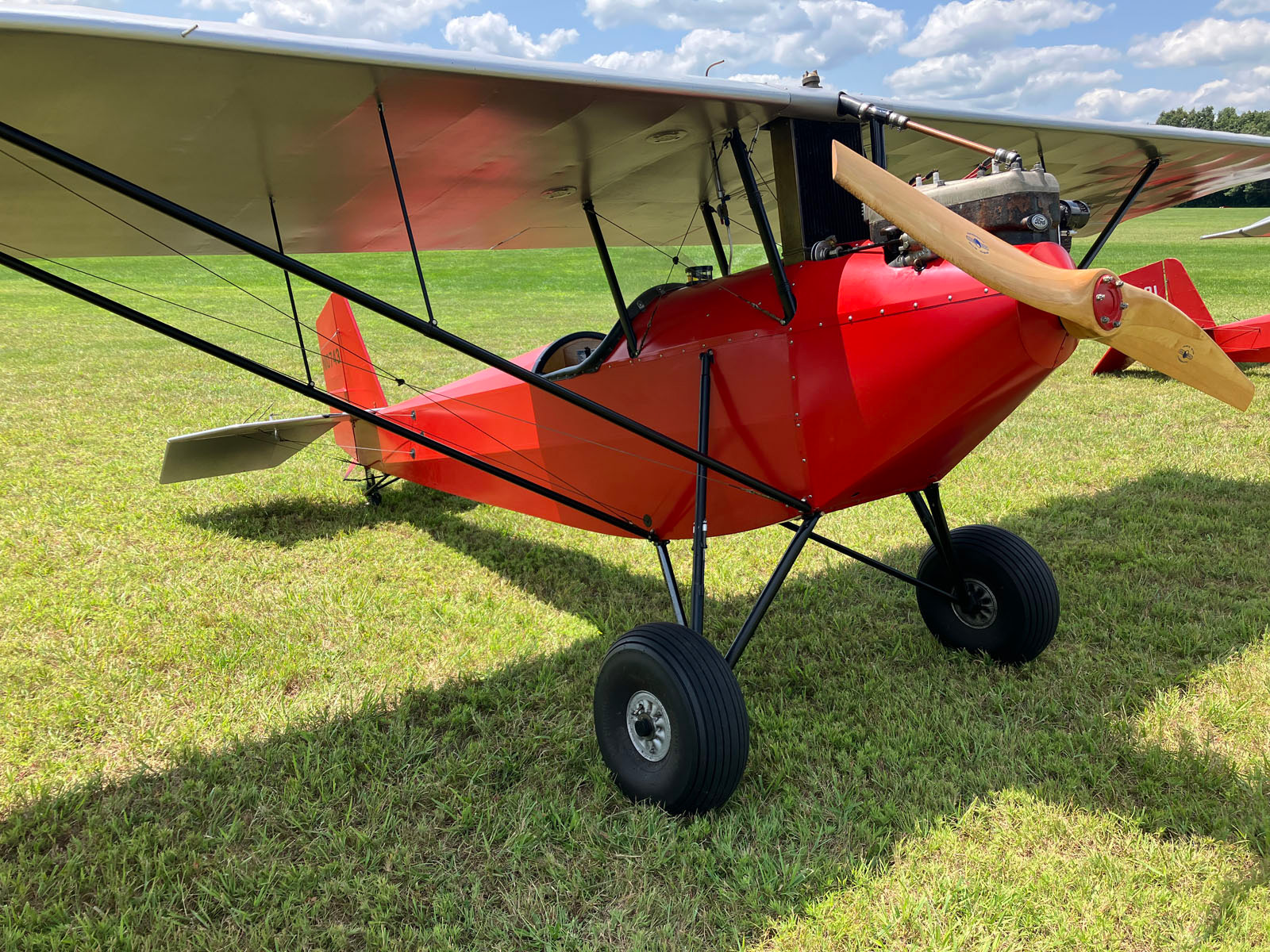 red pietenpol on grassy field