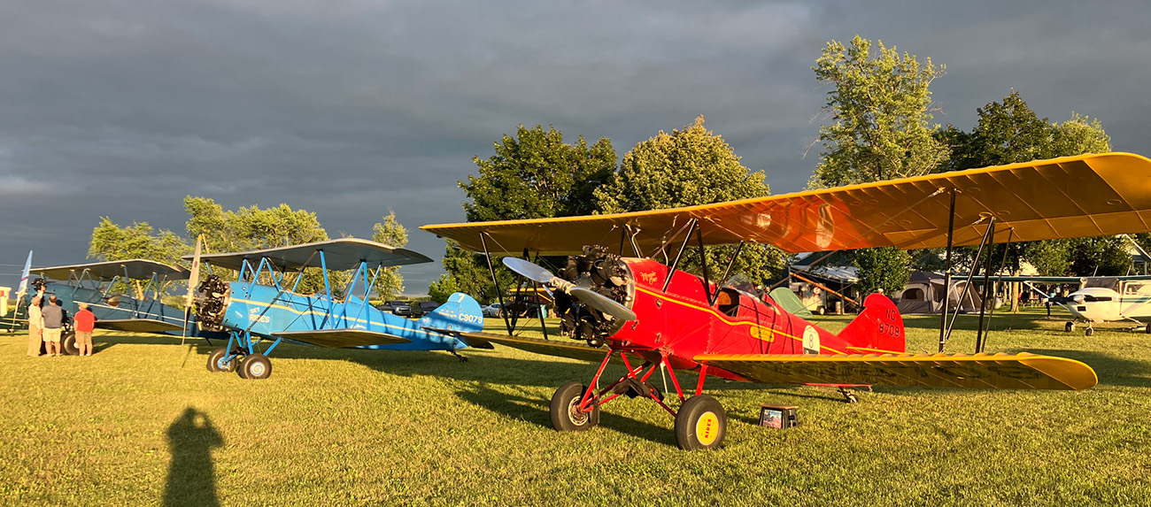 blue and red travel airs parked on the grass at brodhead