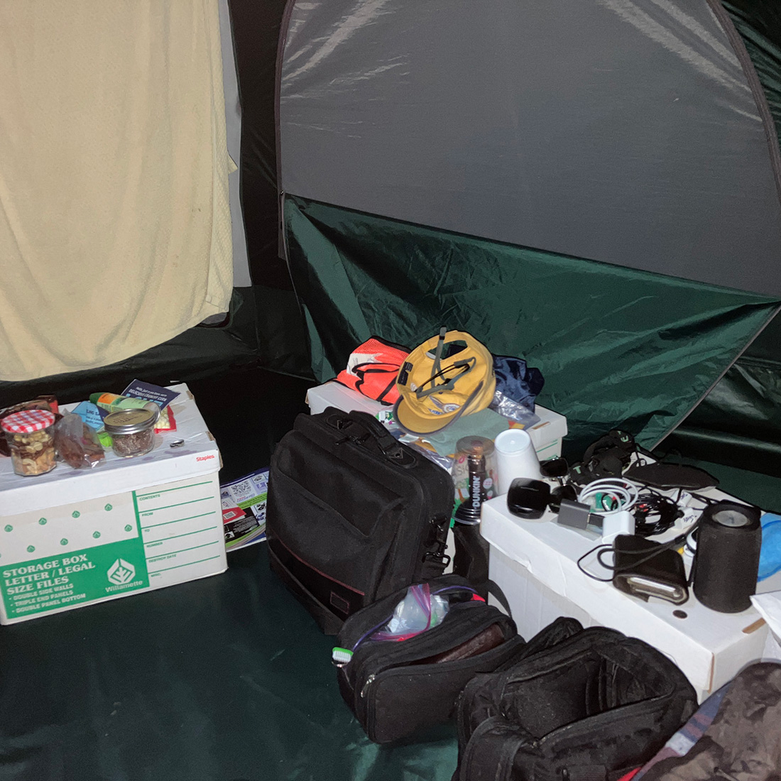 personal items and sleeping cot inside tent