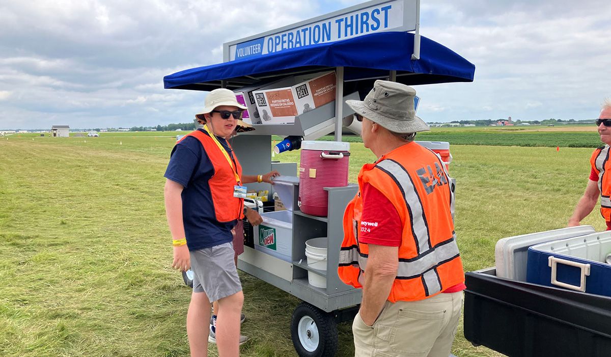 orange-vested volunteers manning a water station called operation thirst