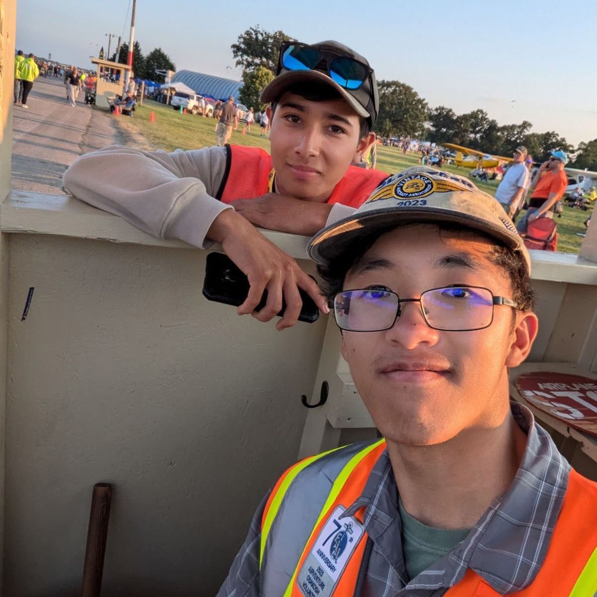 luis membrila and james kurniawan in their orange vests